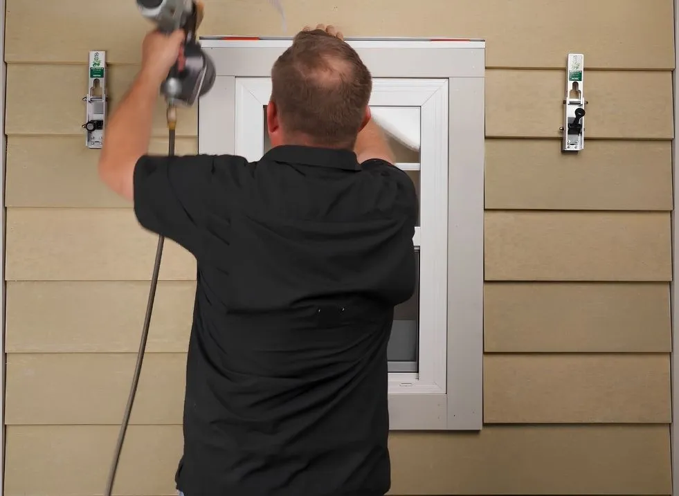 Installer fitting James Hardie siding boards