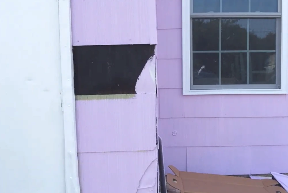 Old siding before replacement, showing wear