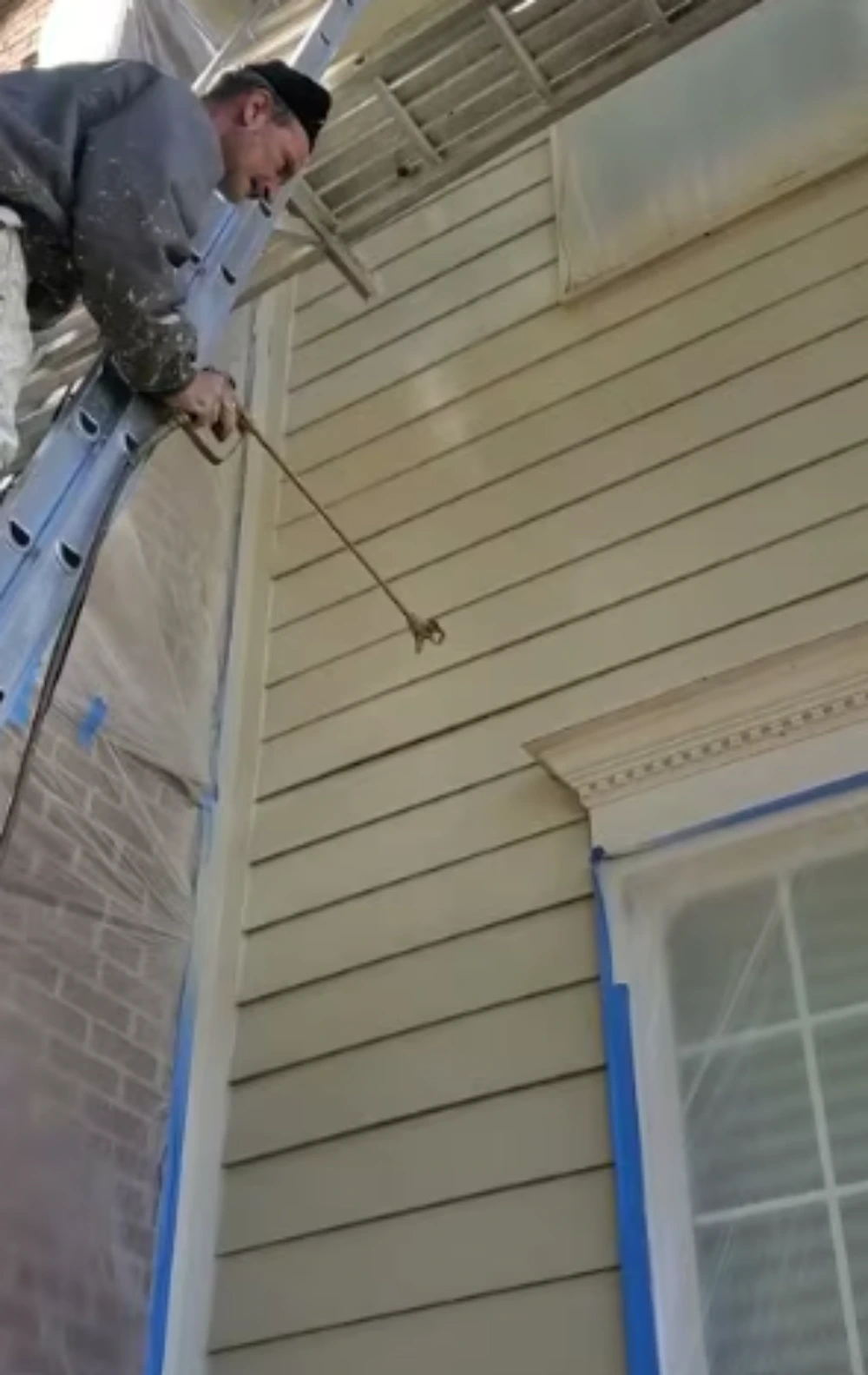 Professional fiber cement siding painter at work in Allen TX