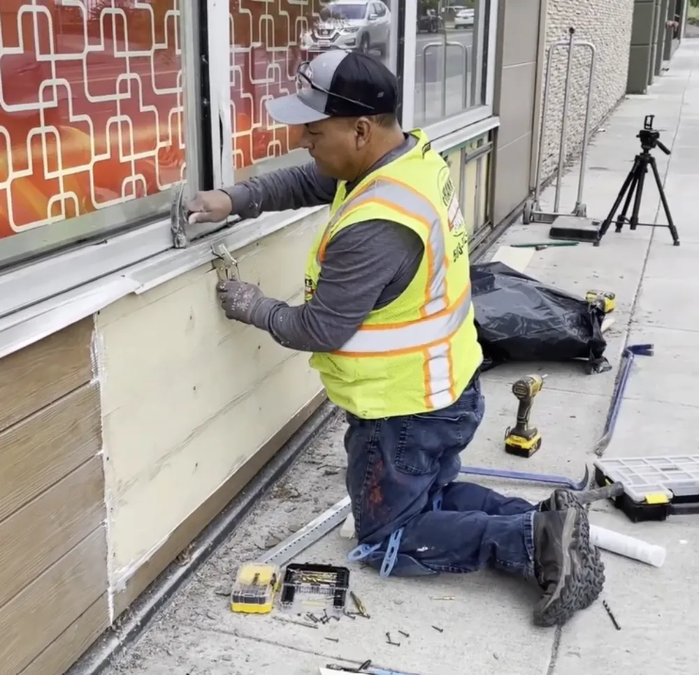 Team repairing fiber cement siding damage