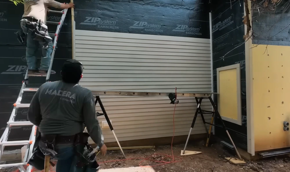 Crew installing cement siding on an Allen home